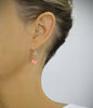 Woman wearing 18K gold plated earrings handmade with Rose Peach Swarovski crystal drop and balls