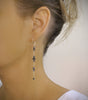 Woman wearing long-length silver plated earrings with "Black Silver Night" Swarovski crystals and pearls