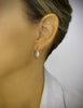 Woman wearing 18K gold plated pink stud earrings with Golden Shadow drops