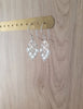 Rhodium plated heart filigree earrings with Blue Shade Swarovski crystals