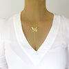 Woman wearing a a medium-length 18K gold plated butterfly Y-necklace
