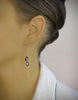 Woman wearing 18K gold plated chain threader earrings with "Black Silver Night" Swarovski crystal drops