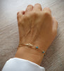 18K gold plated flowerlink bracelet with Indicolite Swarovski crystals on hand