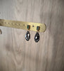 18K gold plated emerald stud earrings with Black Silver Night drops on display