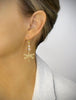 Woman wearing 18K gold plated dragonly earrings with Golden Shadow Swarovski crystals