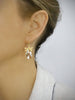 Woman wearing 18K gold plated dragonfly earrings with Golden Shadow Swarovski crystal drops