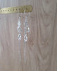 Long-length rhodium plated earrings with Swarovski crystal drops and swirl coins