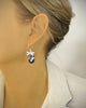 Woman wearing silver dragonfly earrings with Black Silver Night Swarovski crystals drops.