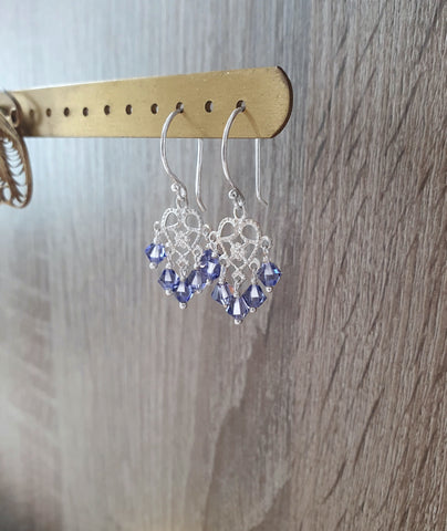 Rhodium plated heart filigree earrings with Tanzanite Swarovski crystals on jewellery display