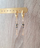 18K gold plated hoop earrings featuring Black Silver Night Austrian crystals and delicate Golden Shadow charms.