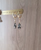 18K gold plated hoop earrings with "Black Silver Night" Austrian crystal drops on display.