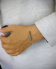 Silver bracelet adorned with dark grey Swarovski pearls and pavé crystal ball.