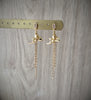 18K gold plated angel earrings with clear crystal earstuds and dangling chains on display