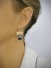 Woman wearing 18K gold plated dragonfly earrings with "Black Silver Night" Swarovski crystal drops.