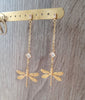 18K gold plated dragonfly and diamond-cut crystal stud earrings on display.