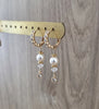 18K goldplated crystal embellished hoop earrings featuring white pearls and clear crystals on display.