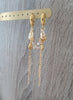 18K gold plated hoop earrings handmade with Golden Shadow Swarovski crystal drops and seashells on display.