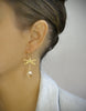 Woman wearing 18K gold plated dragonfly earrings with Golden Shadow Swarovski crystal drops.