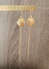 Long-length 18K gold plated seashell dangle earrings on jewellery display