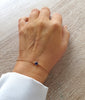 Dige Designs 18K gold plated bracelet decorated with a Majestic blue crystal worn on hand