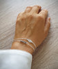 Silver double chain bracelet decorated with flowerlink and Black Silver Night Swarovski crystals worn on hand.