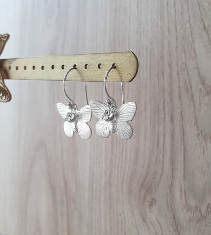Handmade rhodium plated butterfly earrings with Swarovski crystal charms onn display
