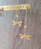 18K gold plated short and long-length dragonfly and crystal earrings on display