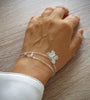 Woman wearing silver double chain butterfly bracelet decorated with clear Swarovski butterfly crystal and charm.