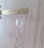 Rhodium plated flowerlink earrings with clear Swarovski crystals on display