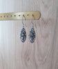 Timeless silver earrings adorned with sparkling grey Swarovski crystal pavé pendants.