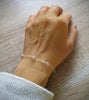 Silver bracelet handmade and decorated with sparkling Silver Shade Swarovski crystals worn on hand.