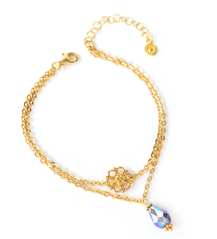 18K gold plated double chain flower bracelet decorated with a Tanzanite AB Swarovski crystal drop.