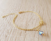 18K gold plated double chain flower bracelet decorated with a Tanzanite AB Swarovski crystal drop.