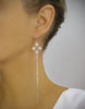 Woman wearing long-length rhodium plated filigree earrings
